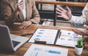 Business people talking at a desk in front of papers