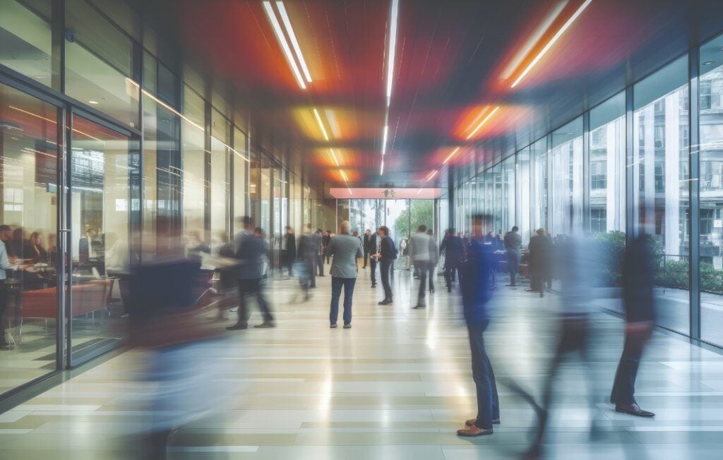 Blurred people moving through hallway