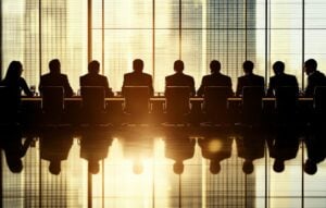 Business leaders strategize in a high-rise boardroom during sunset overlooking the city skyline