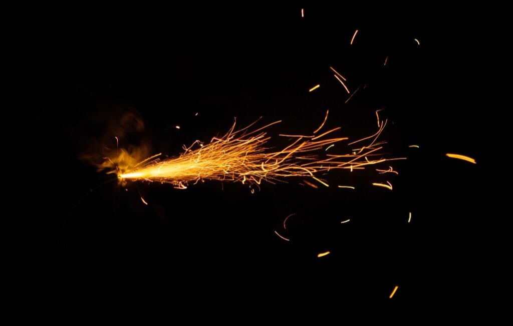 Lit fuse on black background