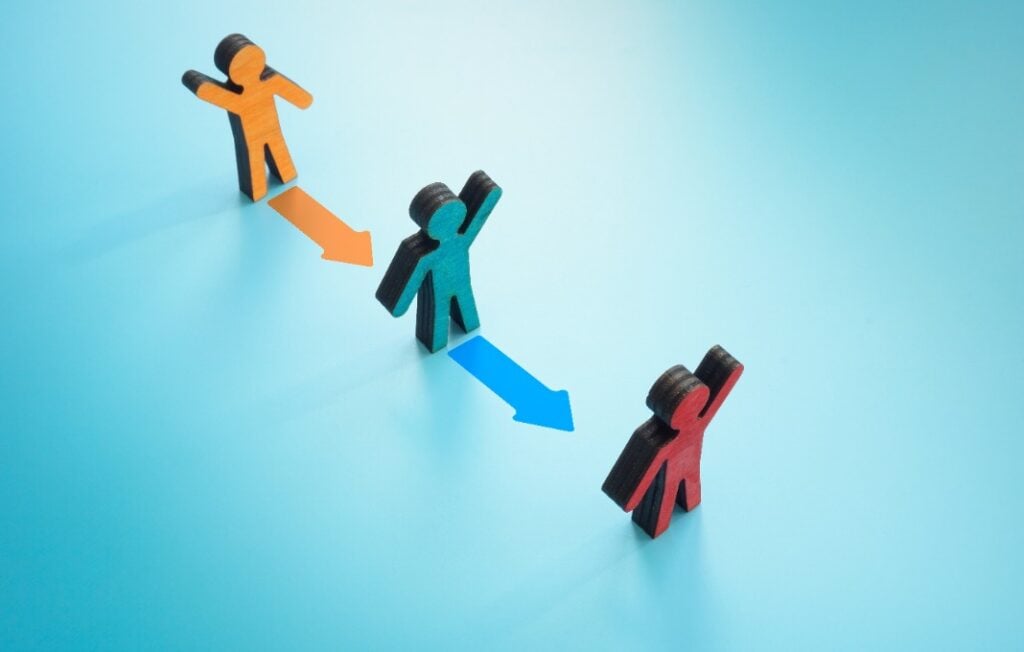 Figurines and colorful arrows. Leadership Transitions concept.
