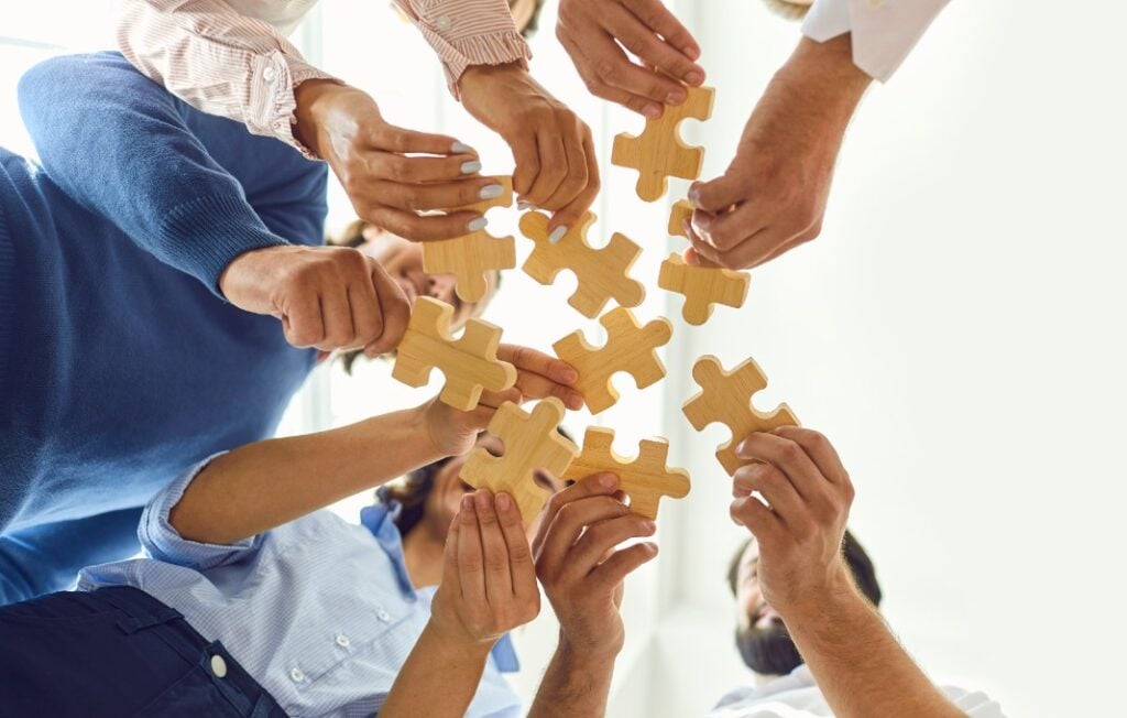 Group holding puzzle pieces together