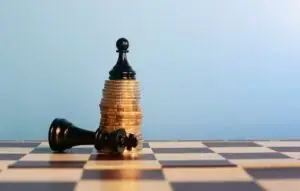 Chess piece on top of a stack of coins