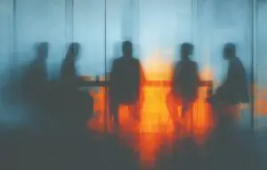 People in a boardroom seen through glass