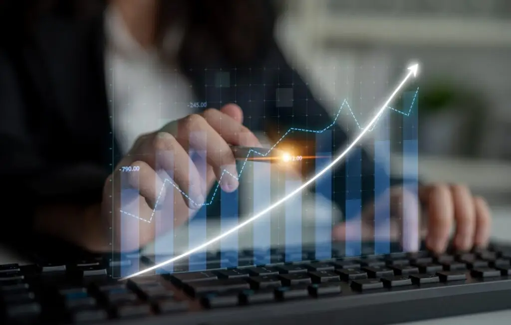 A business professional examines digital financial data on a keyboard