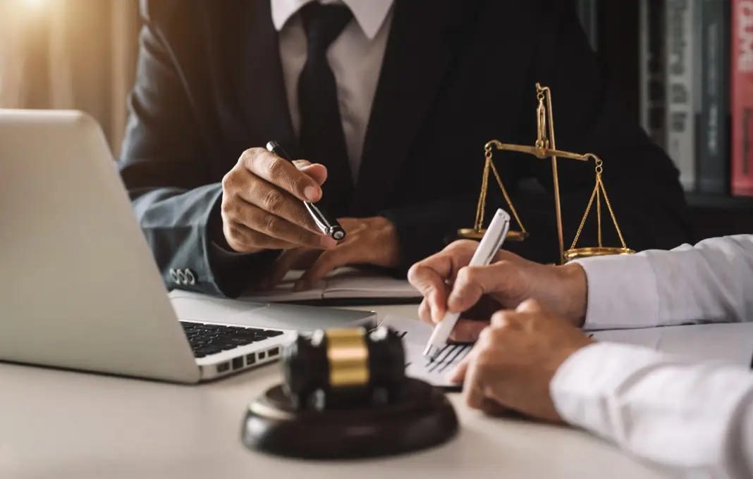business people and lawyers discussing contract papers sitting at the table.