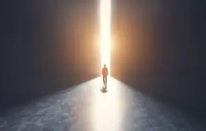 Figure walking through doors into the light