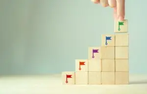 Wooden blocks with colored flags stacked on top of one another