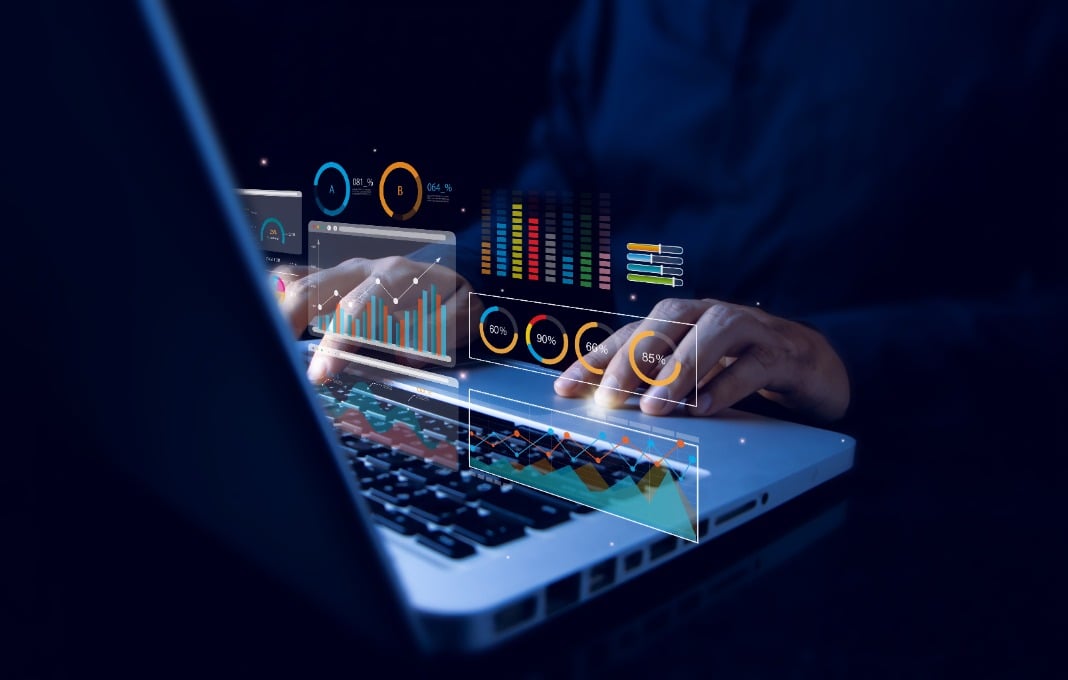 Analyst working with computer in Business Analytics and Data Management System with KPI and metrics connected to the database for technology finance, operations, sales, marketing.