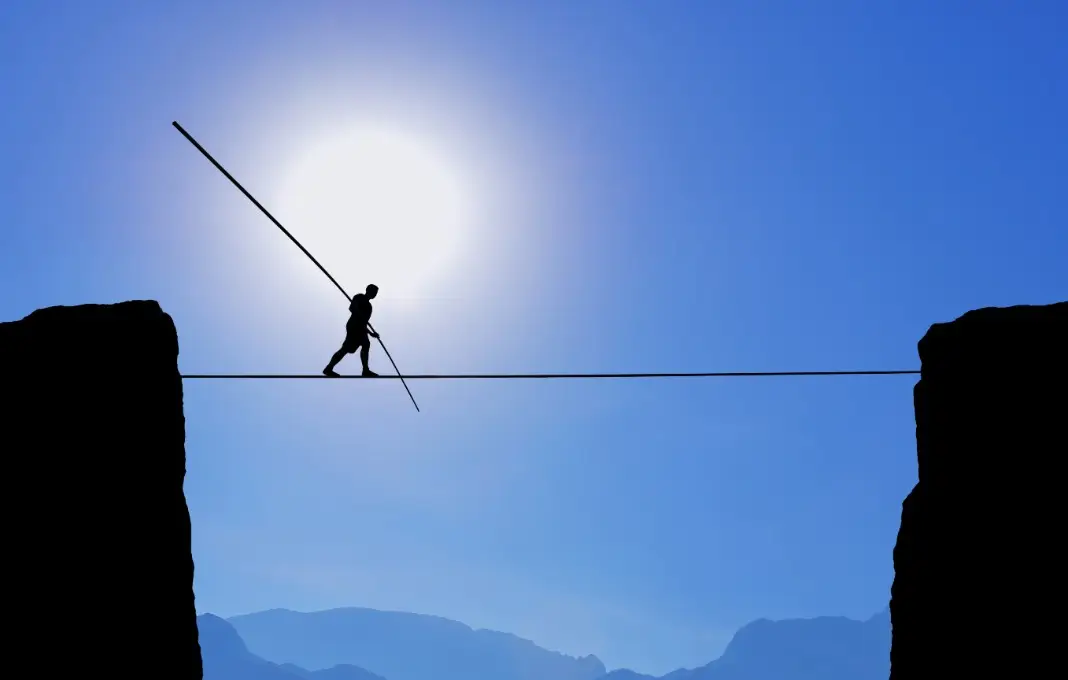 Tightrope walker balancing on rope