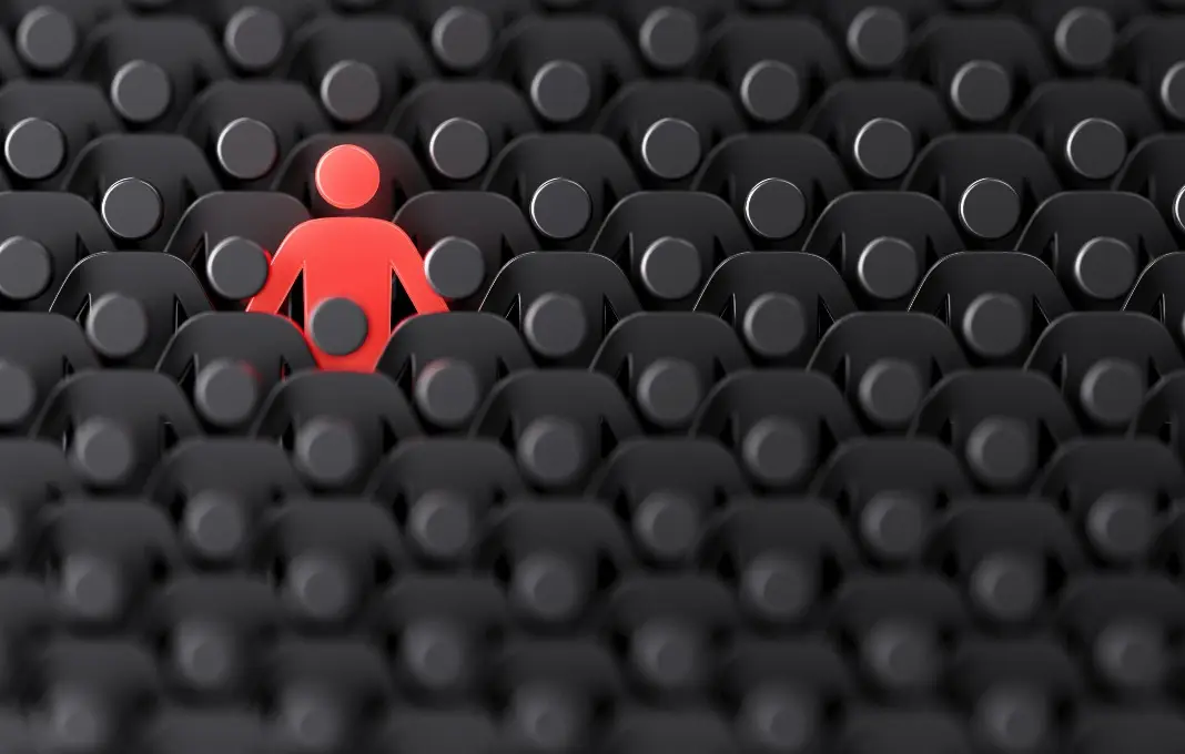 Red human shape among dark ones