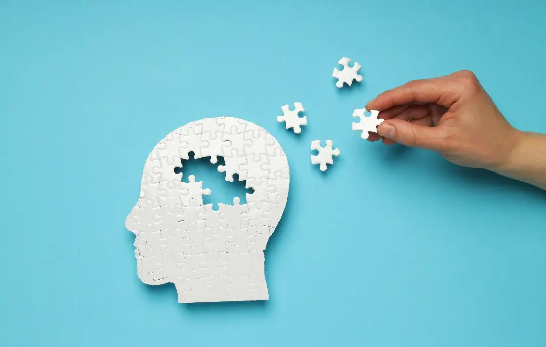 Puzzle head with missing elements on a blue background