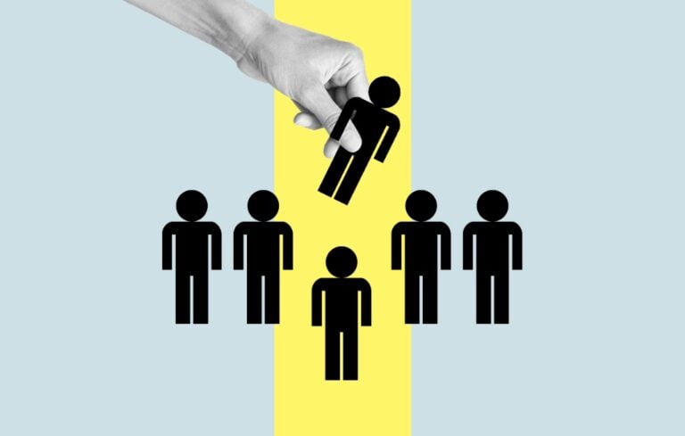 Hand removes cutout of person in a lineup