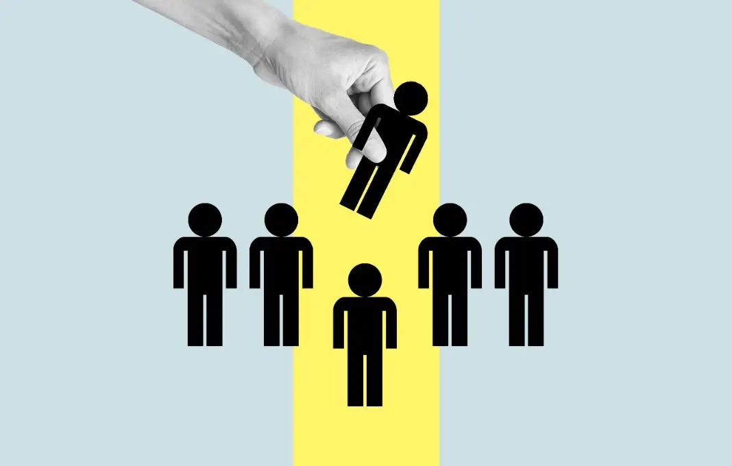 Hand removes cutout of person in a lineup