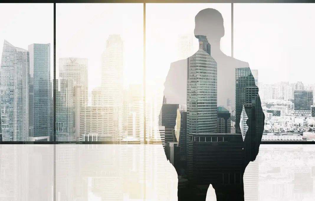 silhouette of business man over office background