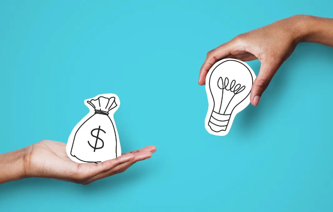Hands with dollar sign bag and white light bulb