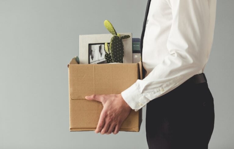 Businessman holding box of belongings