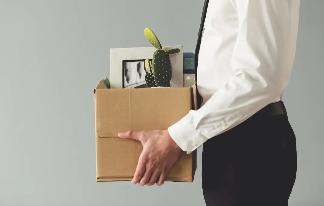 Businessman holding box of belongings